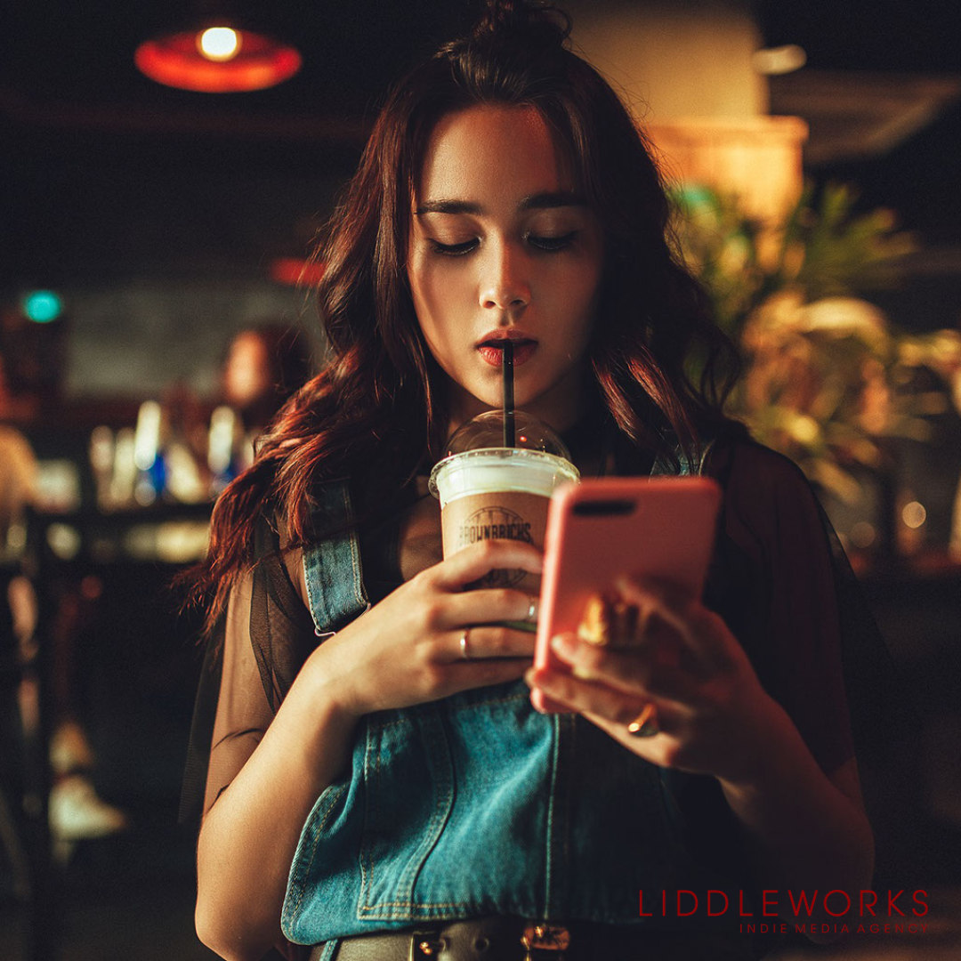 Girl sipping drink on her phone