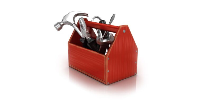 A red open-top tool box filled with a hammer, pliers, a wrench and other tools.